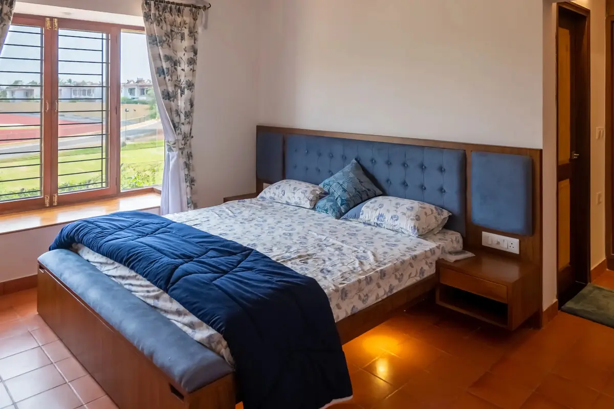 Queen size bed with blue headboard and storage in daughter's bedroom